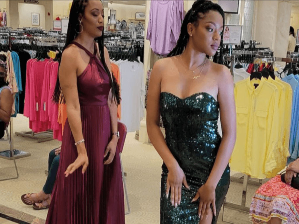 Two Women Dressed in Fancy Dresses in a Store